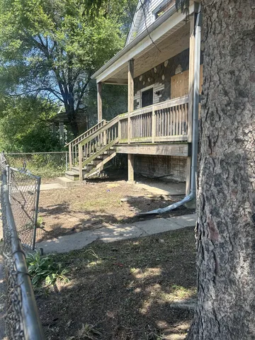 a view of house with backyard and swimming pool