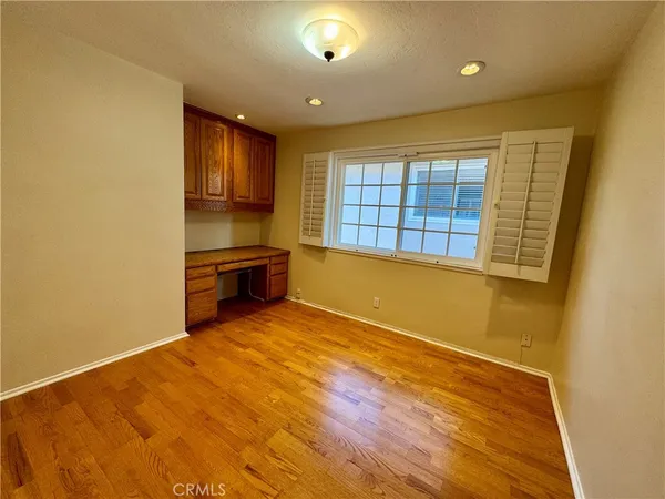 a view of a hallway with wooden shelves