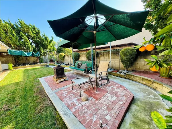 a view of a patio with a table and chairs