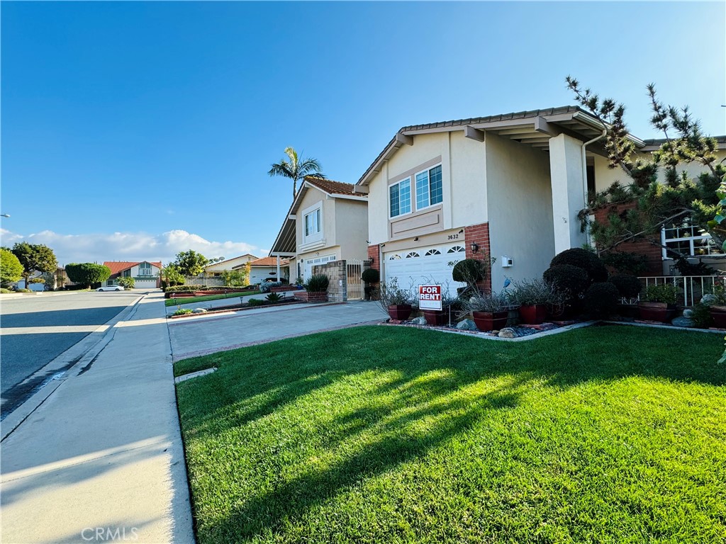 3632 Myrtle Street Irvine, CA 92606 - Photo 36 of 40 a front view of a house with a garden and yard