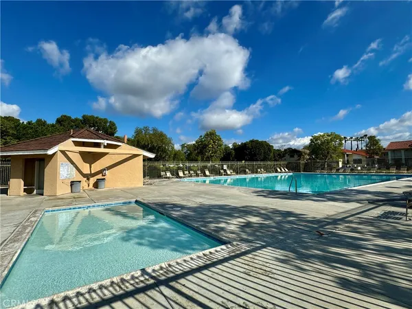 a view of yard with swimming pool and trees