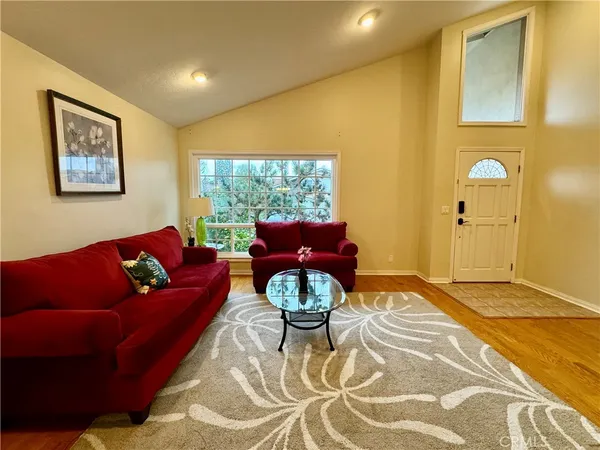 a living room with furniture a rug and a large window