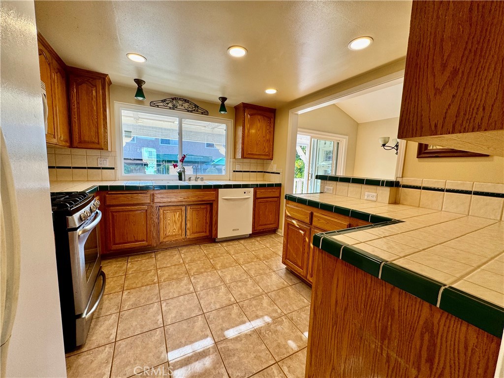 3632 Myrtle Street Irvine, CA 92606 - Photo 6 of 40 a kitchen with stainless steel appliances granite countertop sink stove top oven and cabinets
