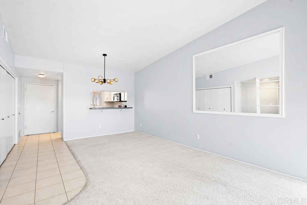 12228 Rancho Bernardo Road, Unit B San Diego, CA 92128 - Photo 12 of 35 a view of a kitchen with a dishwasher and white cabinets
