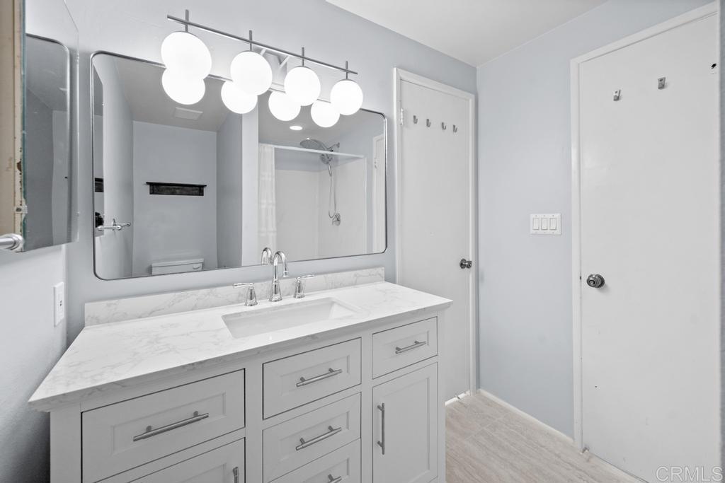 12228 Rancho Bernardo Road, Unit B San Diego, CA 92128 - Photo 15 of 35 a bathroom with a sink vanity and a mirror