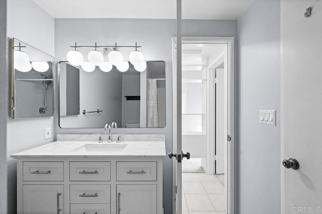 12228 Rancho Bernardo Road, Unit B San Diego, CA 92128 - Photo 16 of 35 a bathroom with a sink vanity and a mirror
