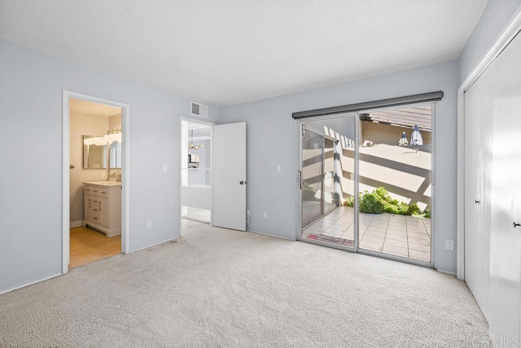 12228 Rancho Bernardo Road, Unit B San Diego, CA 92128 - Photo 19 of 35 an empty room with windows and closet