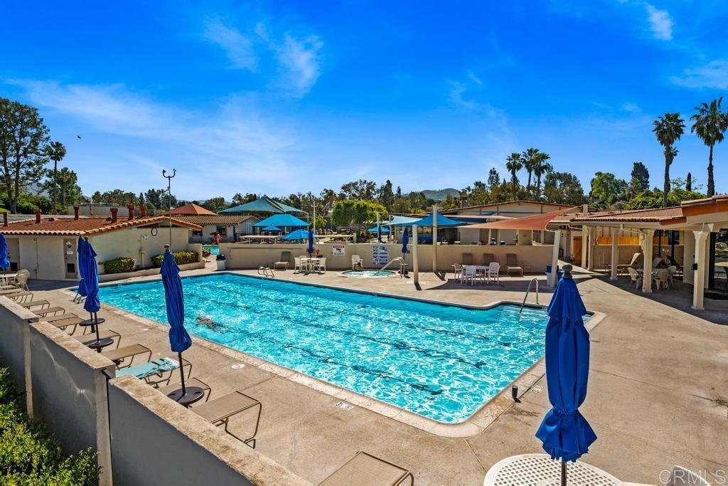 12228 Rancho Bernardo Road, Unit B San Diego, CA 92128 - Photo 33 of 35 a view of a swimming pool with a patio and a yard