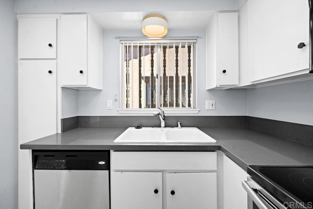 12228 Rancho Bernardo Road, Unit B San Diego, CA 92128 - Photo 6 of 35 a kitchen with a sink cabinets and window