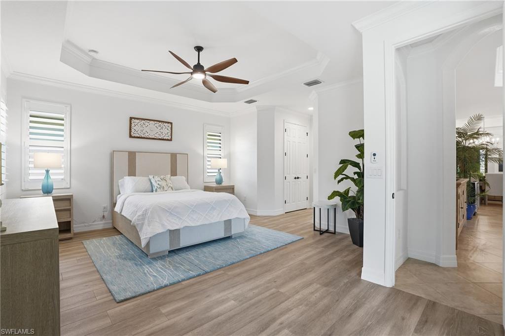 3022 Aviamar Circle Naples, FL 34114 - Photo 17 of 49 a bedroom with a bed and a chandelier