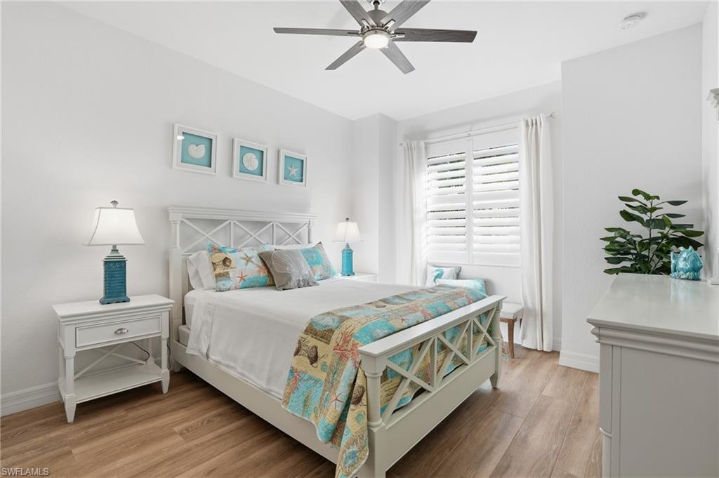 3022 Aviamar Circle Naples, FL 34114 - Photo 21 of 49 a bedroom with a bed table and a window