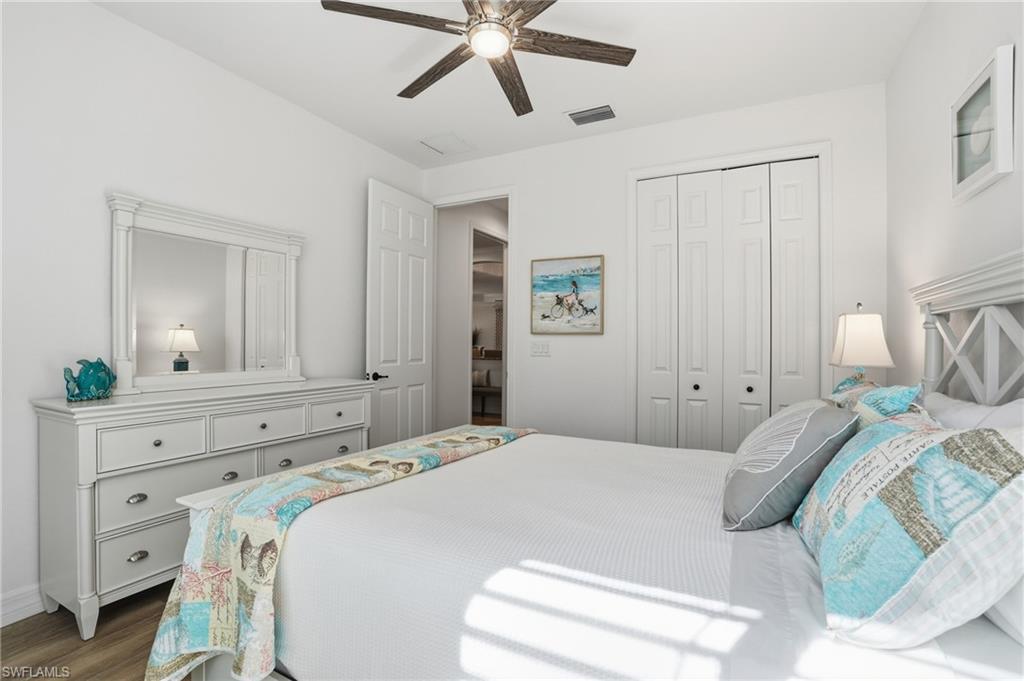 3022 Aviamar Circle Naples, FL 34114 - Photo 22 of 49 a bedroom with a bed and a chandelier