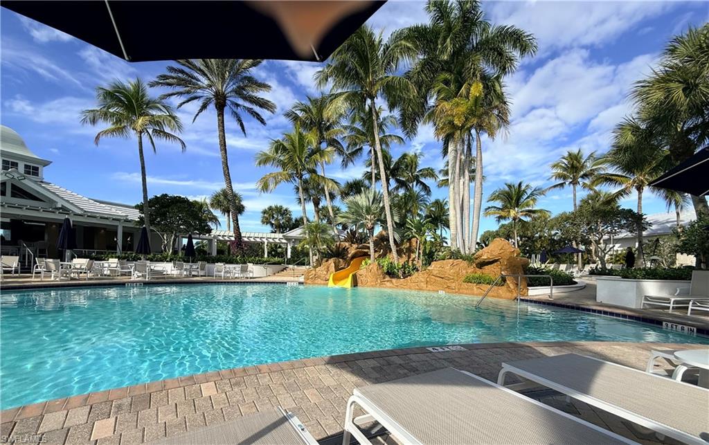 3022 Aviamar Circle Naples, FL 34114 - Photo 42 of 49 a view of a swimming pool with a garden