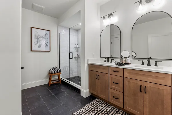 a spacious bathroom with a double vanity sink and a mirror
