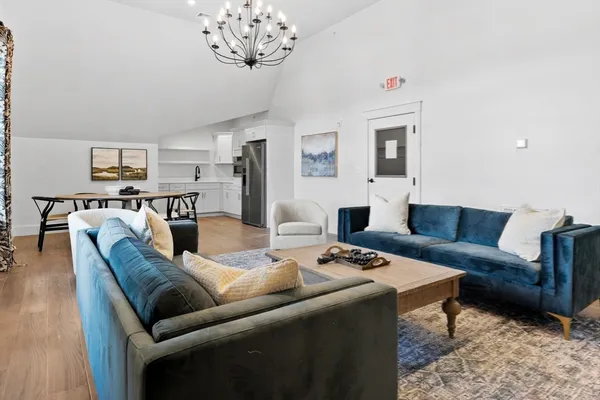 a living room with furniture a couch and a table