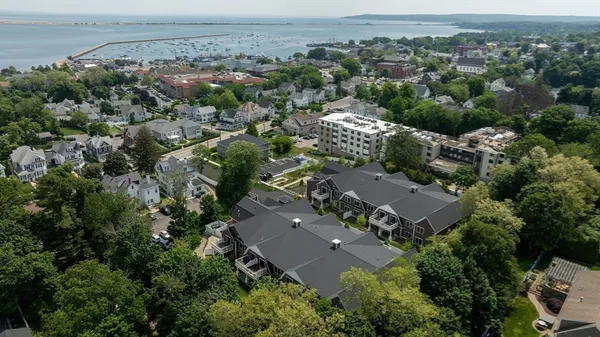 an aerial view of a house with a yard table and chairs