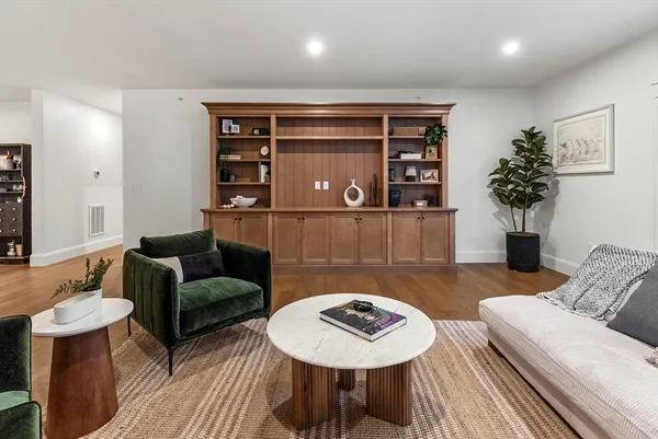 a living room with furniture and wooden floor