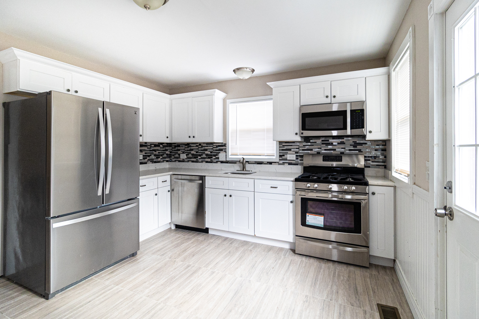 9501 Jackson Avenue Brookfield, IL 60513 - Photo 2 of 5 a kitchen with stainless steel appliances a refrigerator stove and microwave