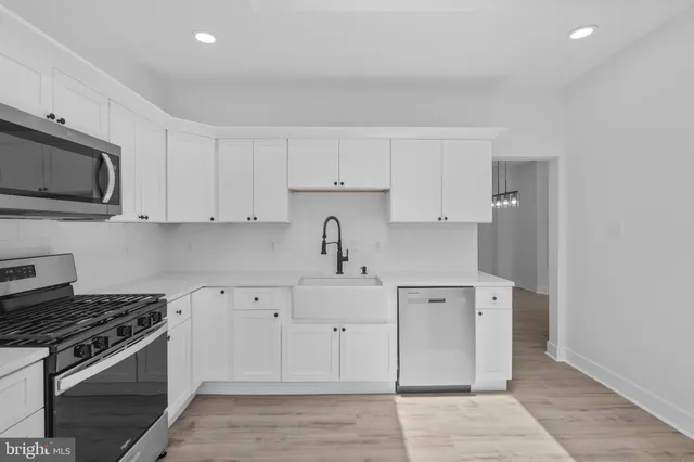 a kitchen with cabinets and appliances