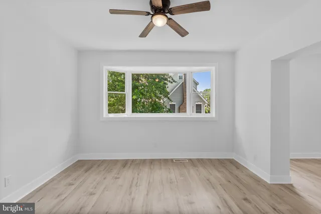 wooden floor in an empty room with a window