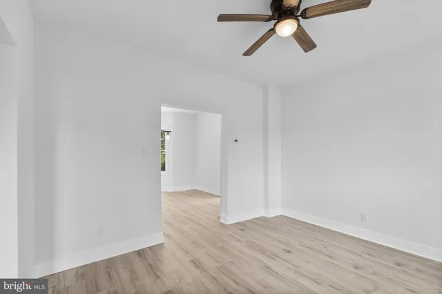 a view of a room with wooden floor and white walls