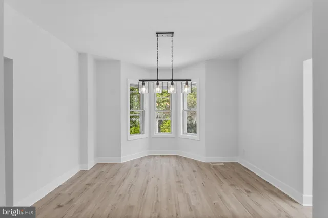 an empty room that has a window in it