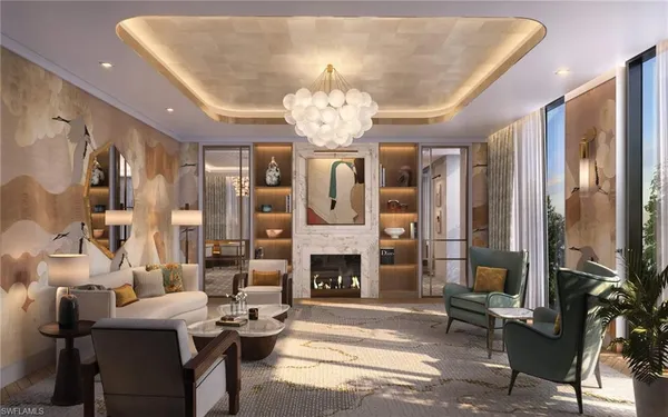 a living room with furniture a fireplace and a chandelier
