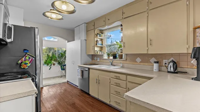 a kitchen with a sink appliances and cabinets