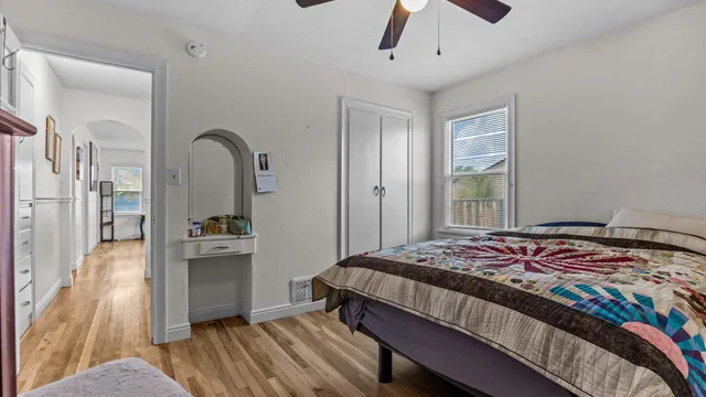 a bedroom with a bed and a view of kitchen