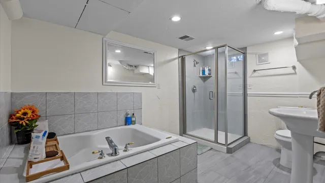 a bathroom with a tub sink and toilet