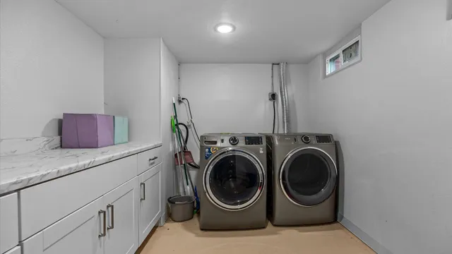 a utility room with sink dryer and washer