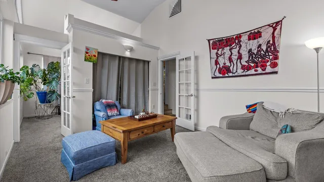 a living room with furniture and a potted plant