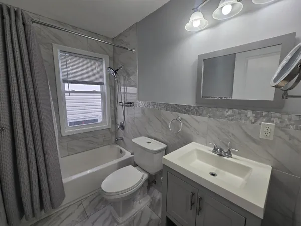 a bathroom with a sink toilet and shower