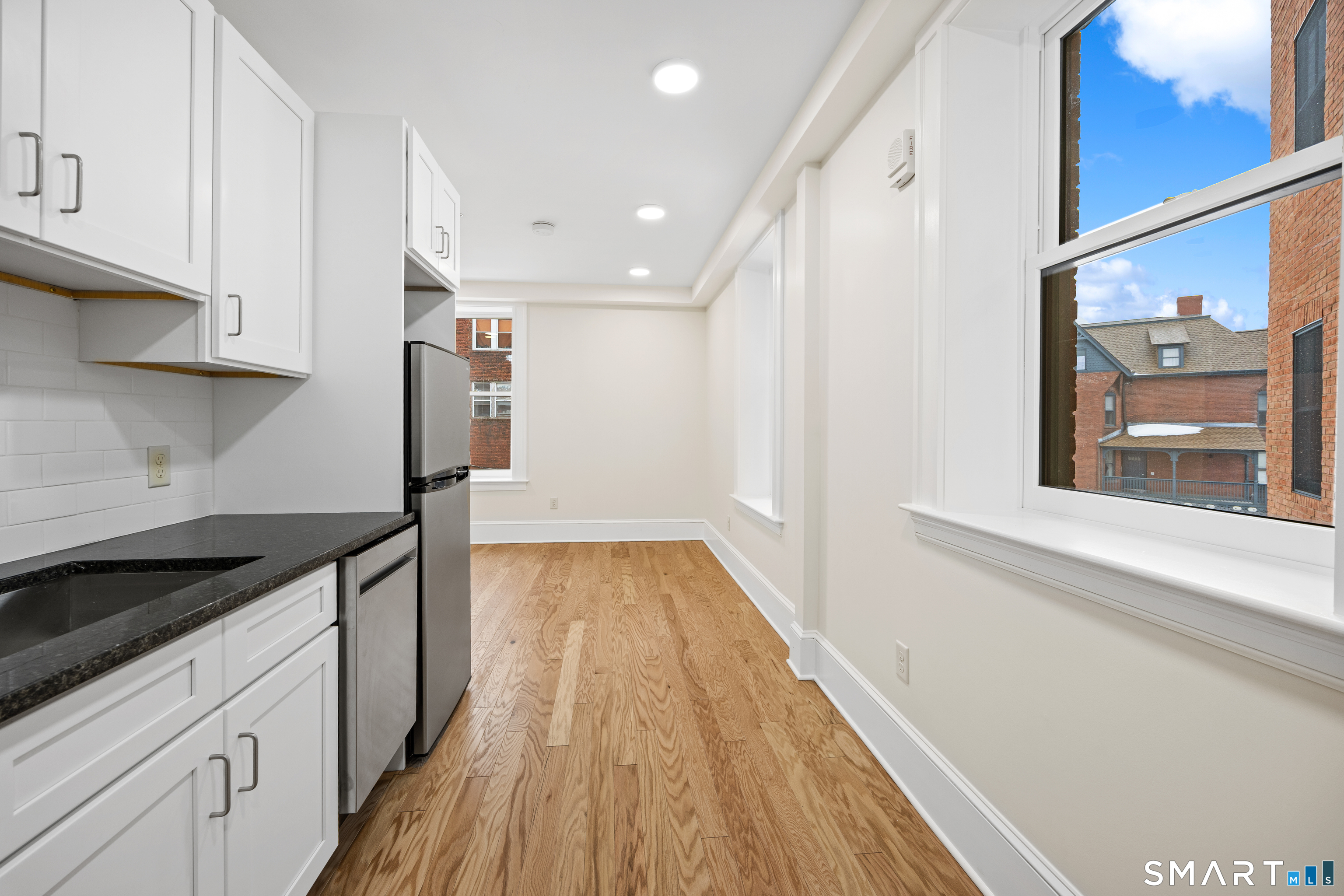 1355 Main Street, Unit 405 Hartford, CT 06103 - Photo 2 of 11 a kitchen with a sink and wooden floor