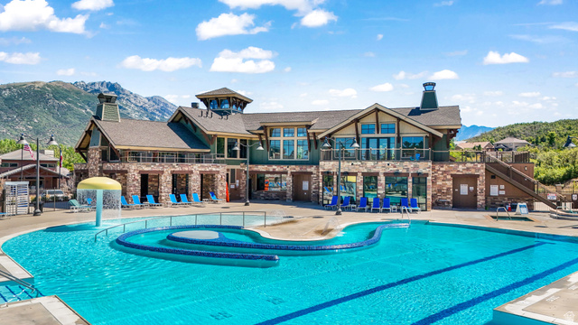 14771 Haddington Road Draper, UT 84020 - Photo 39 of 44 Extensive multi-level swimming pool area featuring a mushroom water feature, a curved seating area, and a surrounding paved deck