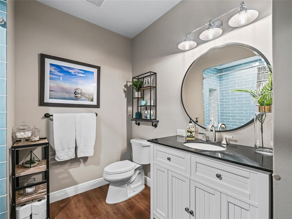 12943 Southeast Sunset Harbor Road Weirsdale, FL 32195 - Photo 42 of 87 a bathroom with a toilet a sink and a mirror