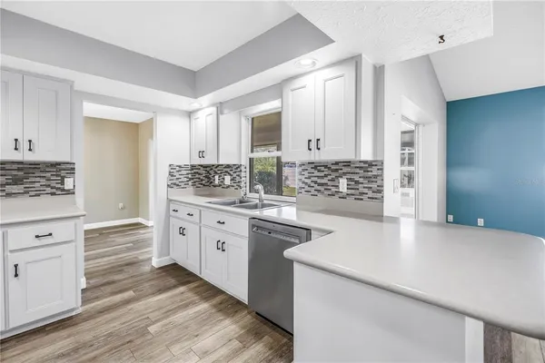 a kitchen with a sink stove and cabinets