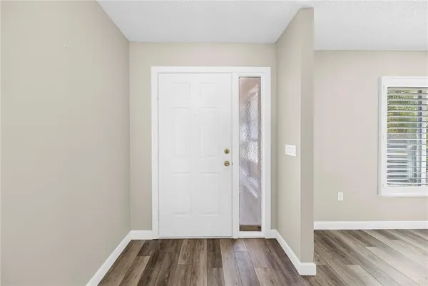 a view of a room with wooden floor and window