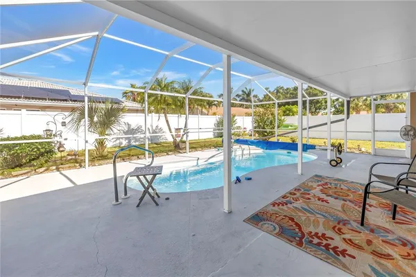 a view of a swimming pool with outdoor seating