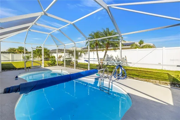 a blue swimming pool is in front of a house