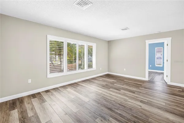 a view of a room with wooden floor and white walls