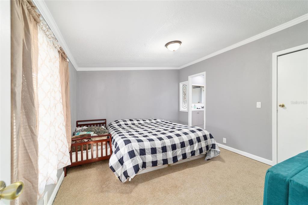 6491 Southeast 185 Terrace Morriston, FL 32668 - Photo 30 of 51 a bedroom with a bed and a window