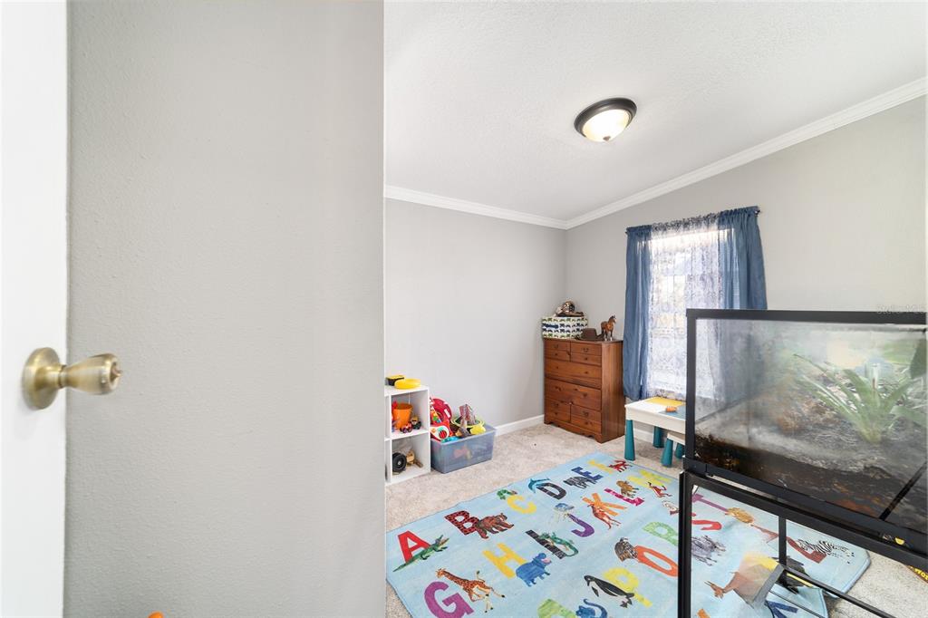 6491 Southeast 185 Terrace Morriston, FL 32668 - Photo 34 of 51 a bedroom with a bed and a window