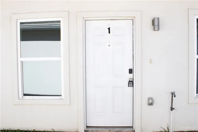a kitchen with white cabinets sink and stainless steel appliances