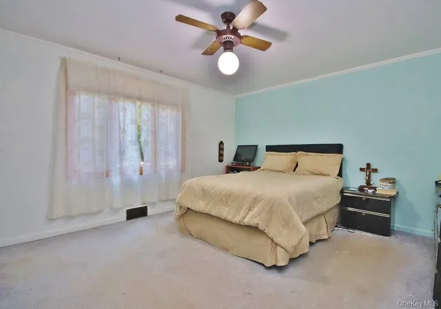 a bedroom with a bed and a ceiling fan