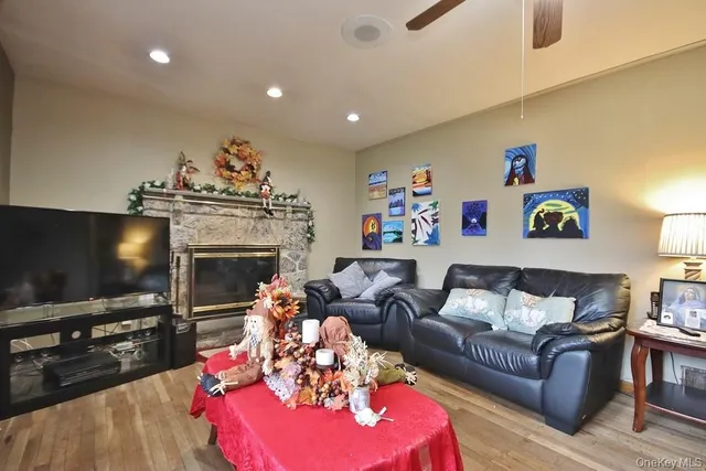 a living room with furniture a flat screen tv and a fireplace