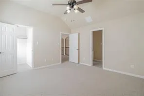 an empty room with chandelier fan and closet
