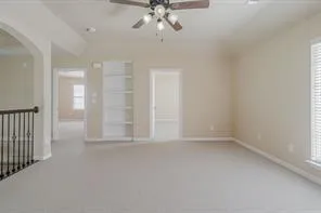 en empty room with windows and ceiling fan