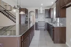 a kitchen with stainless steel appliances granite countertop a sink and cabinets