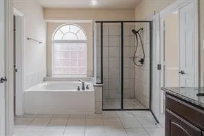 a bathroom with a tub a sink and a window